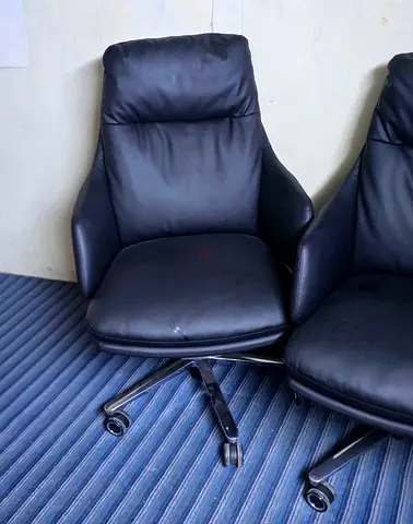 Black leather swivel office chair with wheels - good condition