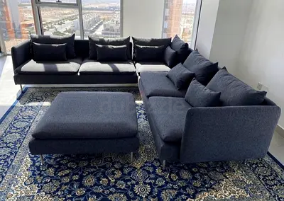 Modern design corner sofa with soft cushions and comfortable seating. Grey fabric finish with many c