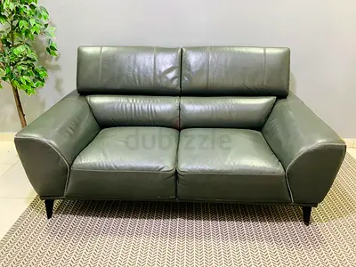 Compact 2-seater leather sofa in dark green — good condition