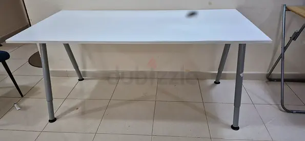 Simple white dinning table with adjustable legs - good condition