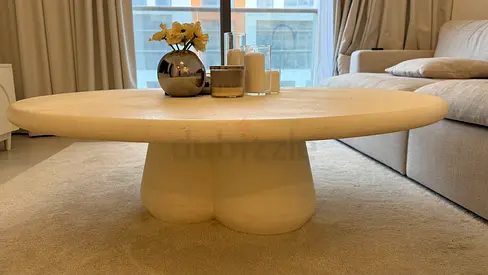Low round sculptural coffee table in beige plaster finish