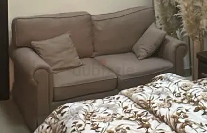 Compact 2-seater beige sofa in good condition