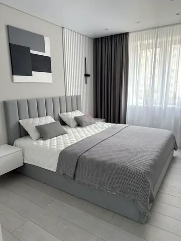 Modern grey upholstered Queen size bed with storage and medical mattress