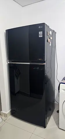 LG double-door refrigerator in good working condition, black with Glass