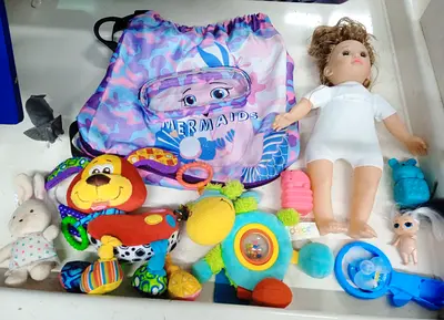 Mixed baby toys bundle with doll, rattles and plushes — preowned