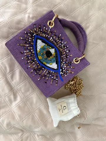 Purple beaded handmade handbag with eye motif and gold chain