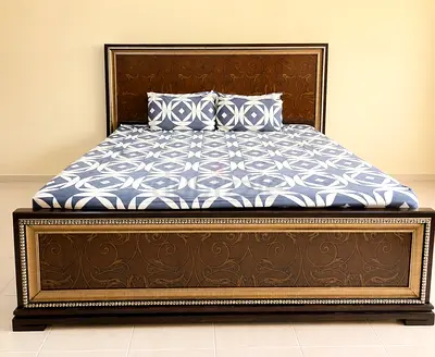 Super King size wooden bed frame with carved headboard and footboard along with fitting mattress