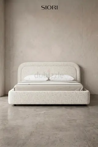 Modern upholstered double bed with curved headboard