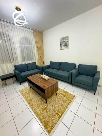 One-bedroom apartment with a living room, located directly off the Dubai exit.