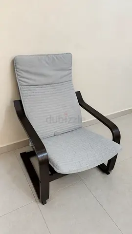 IKEA Comfortable gray cushioned lounge chair with dark wooden frame