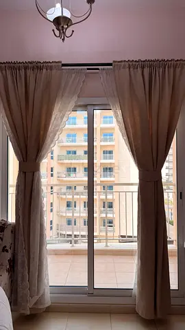 Beige fabric curtains with tiebacks