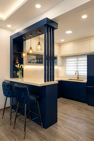 Modern navy blue kitchen island with breakfast bar and pendant lights