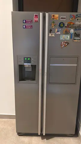 Side-by-side stainless refrigerator with water/ice dispenser - good condition