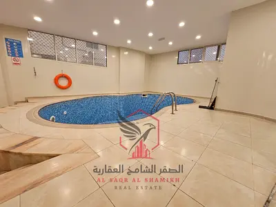 Free gym & pool, central A/C, central gas, family tower, free maintenance. Spacious 2-bed, balcony, 2 baths, Al Qasimia Al Nad.