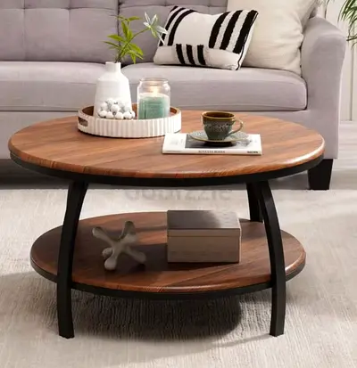 Round wooden coffee table with lower shelf and black metal legs