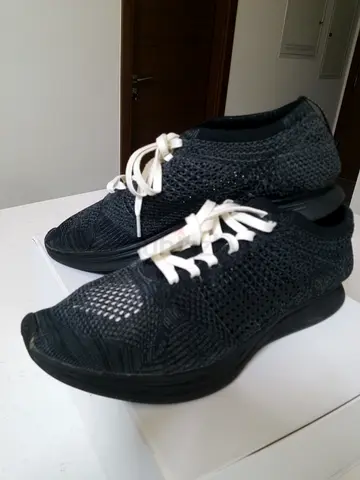 Black nike knit slip-on sneakers with white laces - gently used