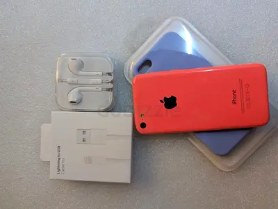 My used iPhone 5c with charger, EarPods and two silicone cases