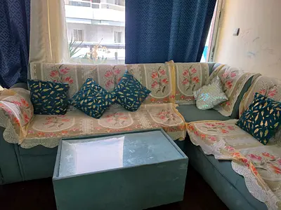 Corner sofa set with glass-top coffee table — good condition
