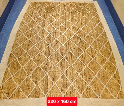 Natural handmade jute rug 220 x 160 cm with white border and diamond pattern. New. Unused. AED 365.