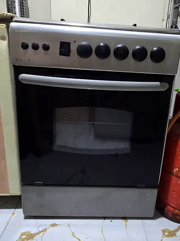 Used 4 burner gas oven, rotisserie,baking and stove (with safety function), stainless steel finish.