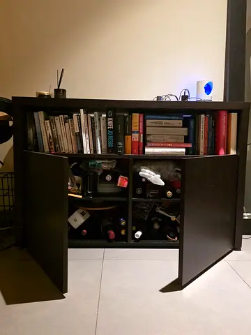 Compact dark wood cabinet with bookshelves and wine storage