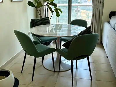 4-seater dining set with round marble-like table and upholstered chairs