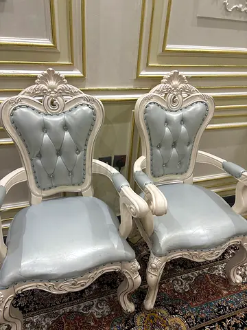 Pair of vintage-style carved dining chairs with light blue upholstery