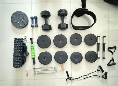 Home gym kit — dumbbells, weight plates, resistance straps, and accessories (light usage)