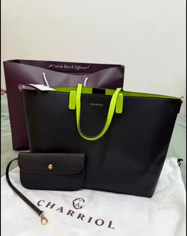 Charriol black leather tote bag with vibrant neon yellow.