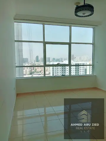Stunning 2-Bedroom Apartment with Living Room for Annual Rent in Orient Towers – Ajman, featuring a dedicated parking space, premium finishes, a prime