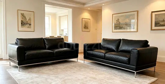 Pair of Black Leather Sofas with Stainless Steel Base - Good Condition