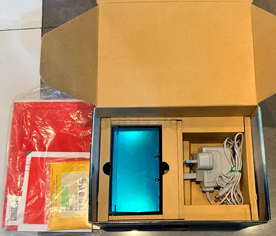Nintendo 3DS handheld console with charger and manuals - good condition