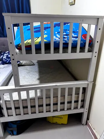 White wooden bunk bed with two mattresses, one new and the other in excellent condition
