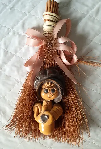 Small decorative broom with ceramic figurine