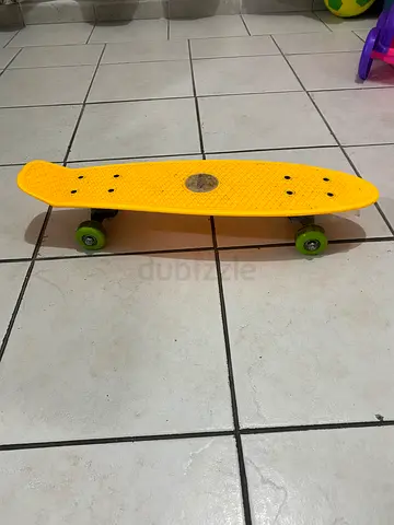 Used yellow cruiser skateboard / penny board with green wheels