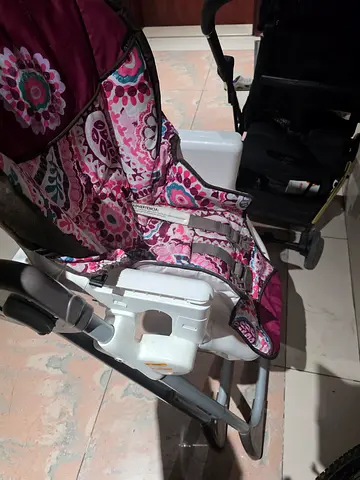 Used pink patterned baby high chair with tray