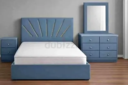 Blue upholstered double bed frame with matching dresser, mirror and bedside tables