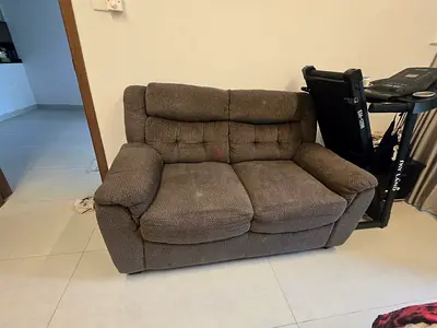 2-seater brown fabric loveseat in good used condition