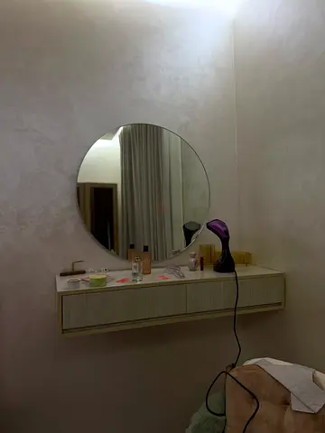 Wall-mounted floating vanity shelf with round mirror