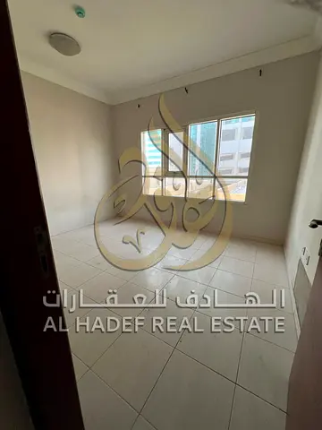 Two rooms and a hall for rent in Al Majaz 1 next to Dubai Bus Station, excellent location, modern building, free maintenance, 39,000 dirhams, 4 instal