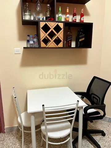 Compact white dining table with 2 chairs and office chair-AED 100 & Wine Drawer-AED 300