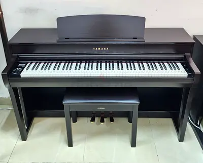 The Yamaha Clavinova CLP-745R (Dark Rosewood finish) is an 88-key digital upright piano featuring