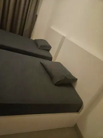 Pair of single beds with white frames and headboards (used)