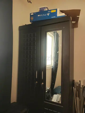 Dark wood wardrobe with full-length mirror and storage cabinet