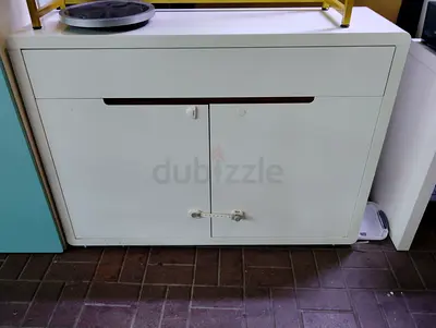 White two-door storage cabinet with top drawer - good condition