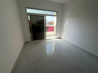 Available for annual rent in Ajman (Al Muwaihat 3): A spacious unit featuring two bedrooms, a living room, three bathrooms, a balcony, and a kitchen.