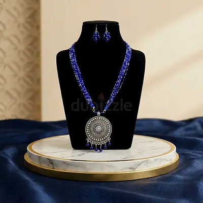 Handmade blue beaded necklace with matching earrings and silver pendant