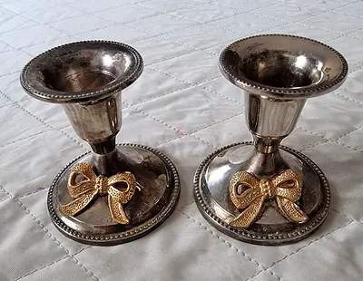 Pair of vintage silver-plated candlesticks with gold bow accents
