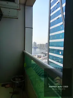 2BR hall in Orient Towers with parking, annual rent AED 50,000, 4 payments, AED 4,000 security chequ