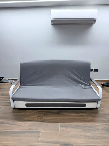 Grey fabric sofa bed in pristine condition (folds out to bed)